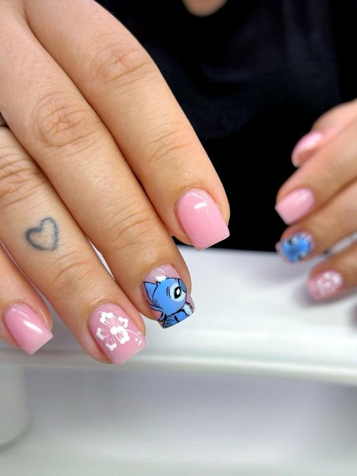 Pink nails with hand-painted nail art and a blossom